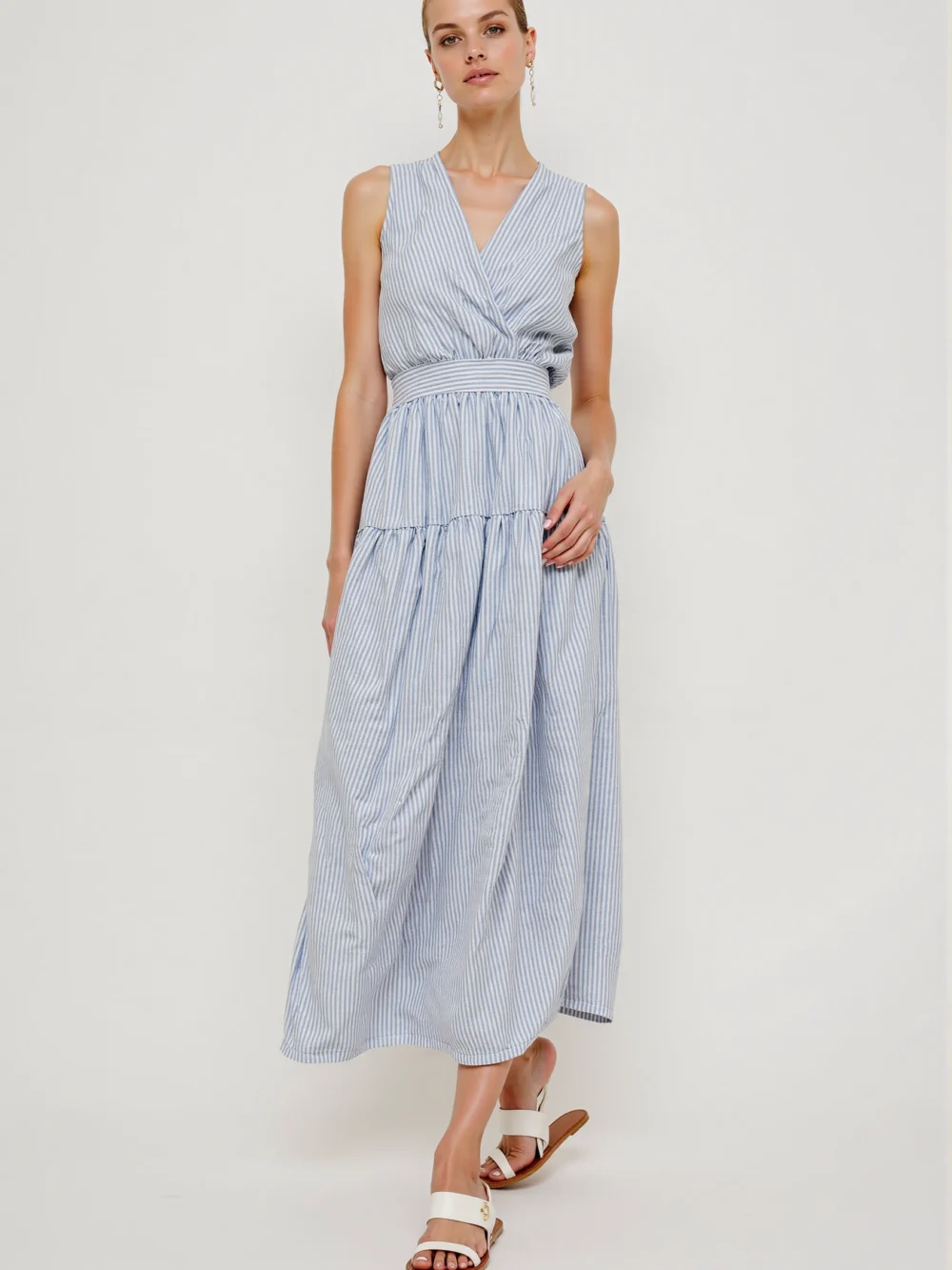 Blue & white striped maxi dress with sleeveless, V-neck, wrap design, featuring a simple elegant style, suitable for daily wear or vacations.