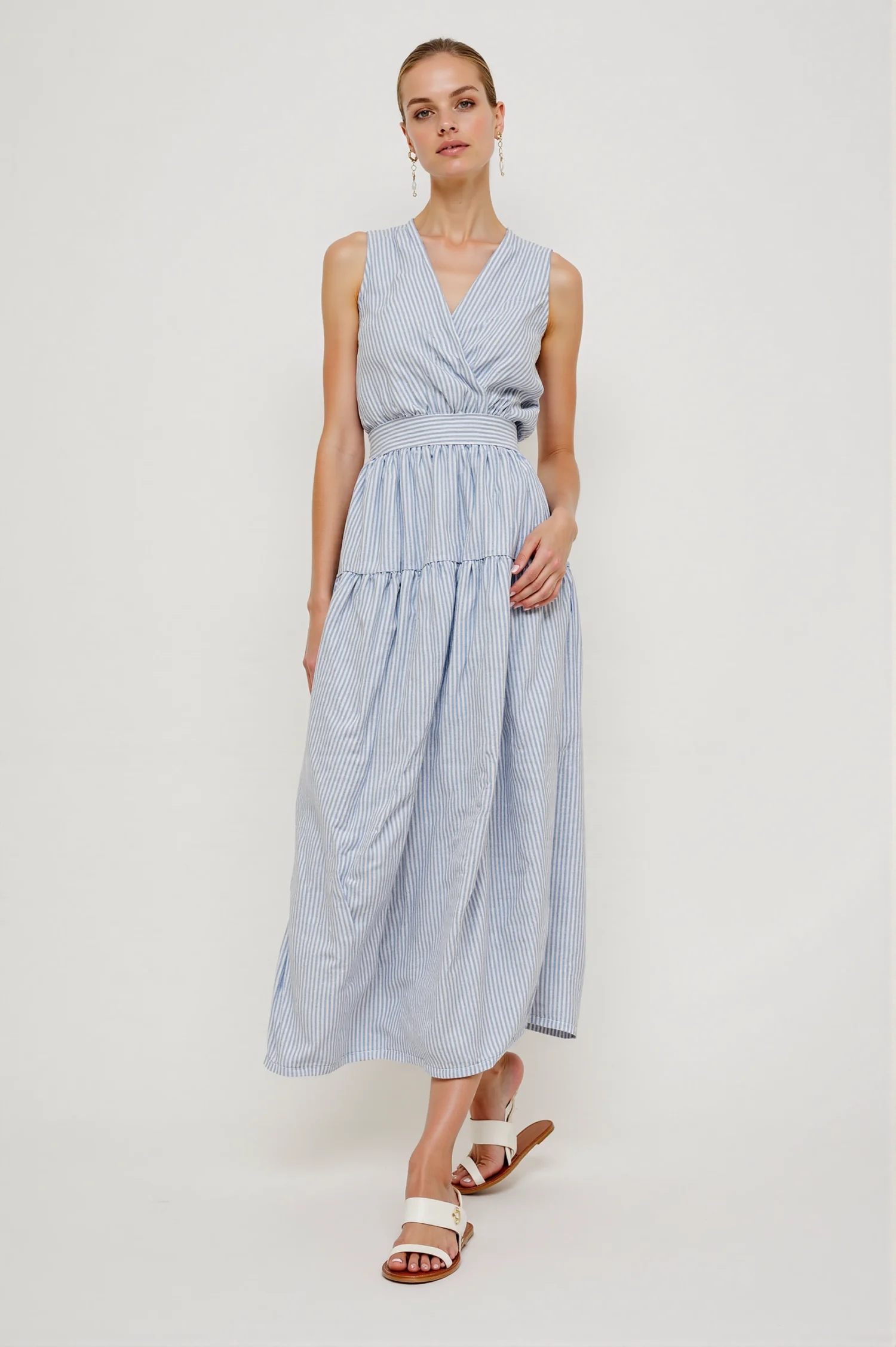 Blue & white striped maxi dress with sleeveless, V-neck, wrap design, featuring a simple elegant style, suitable for daily wear or vacations.