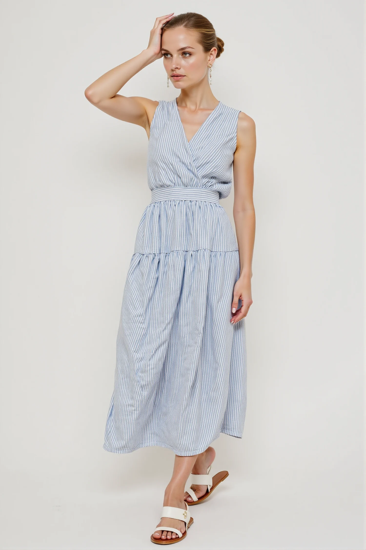 Blue & white striped maxi dress with sleeveless, V-neck, wrap design, featuring a simple elegant style, suitable for daily wear or vacations.