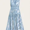 Blue & white maxi dress with leaf print, featuring wrap design, tiered skirt, and an elegant natural style, suitable for daily wear or vacations.