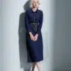 Dark blue belted denim shirt dress with collar, front buttons, pockets, featuring a minimalist and elegant design, suitable for daily or light formal wear.