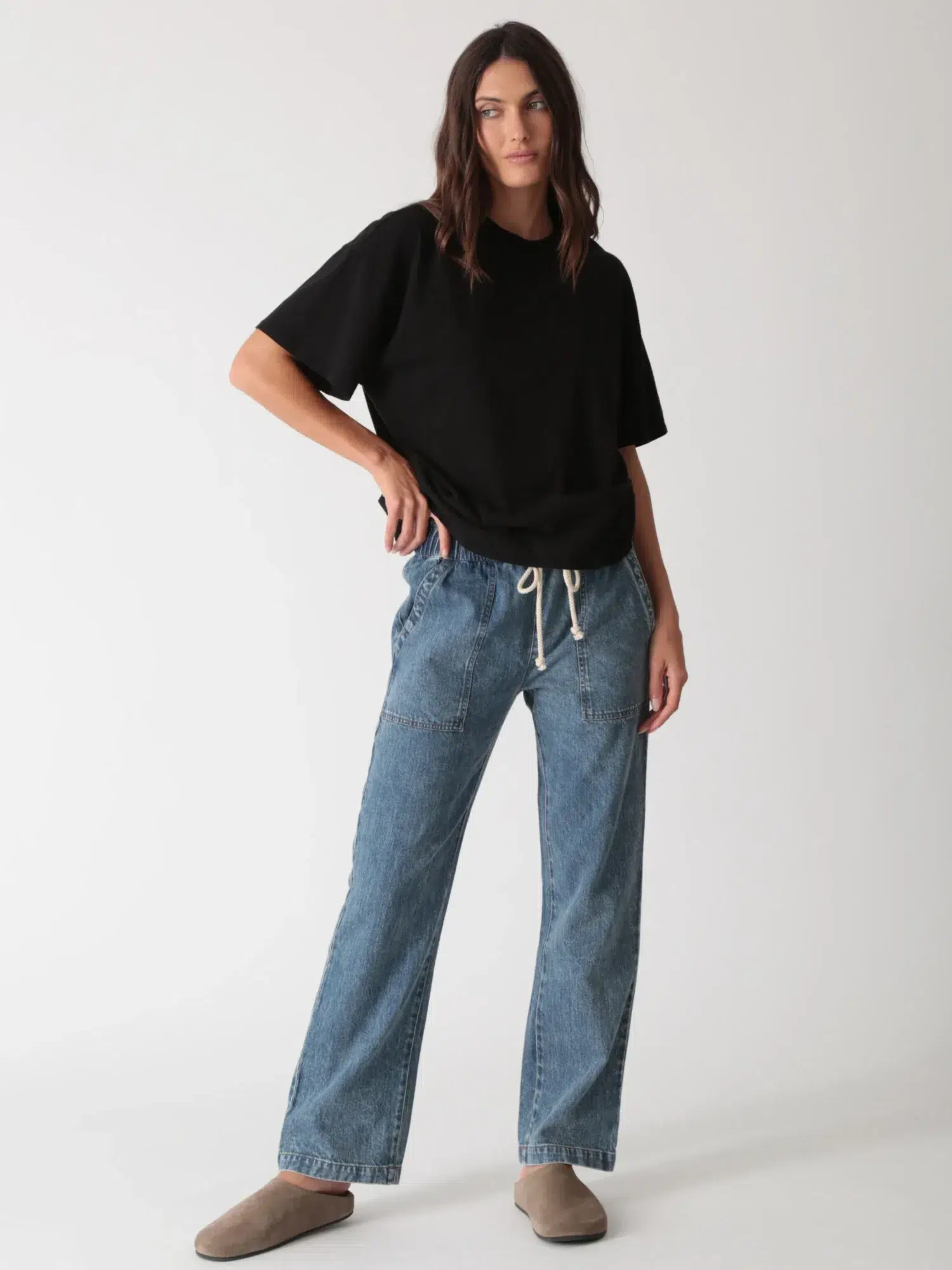 Classic linen - cotton casual denim jeans styled with black short - sleeve top
