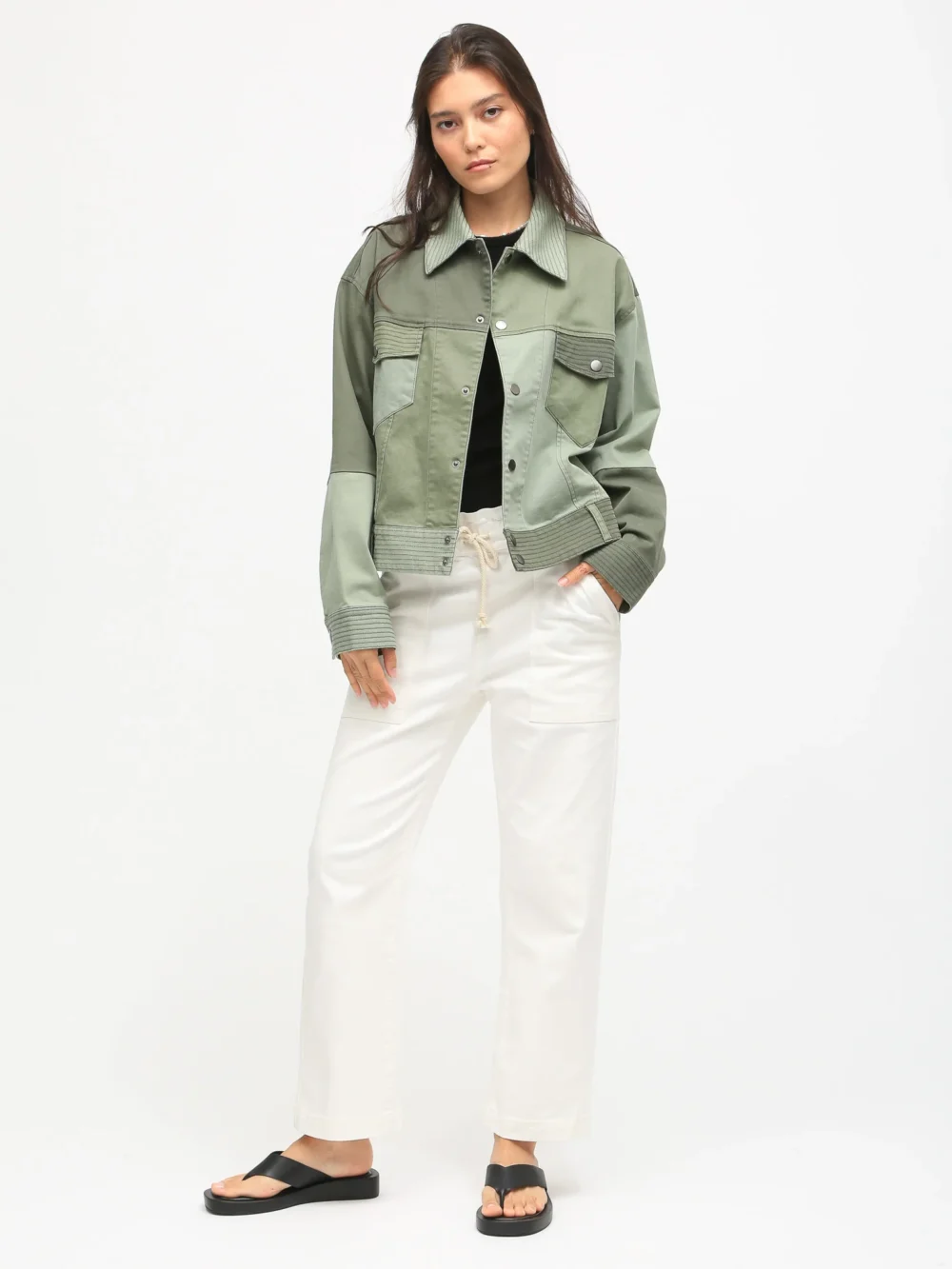 Dyed patchwork jacket with olive green tone design, styled with black top and white pants