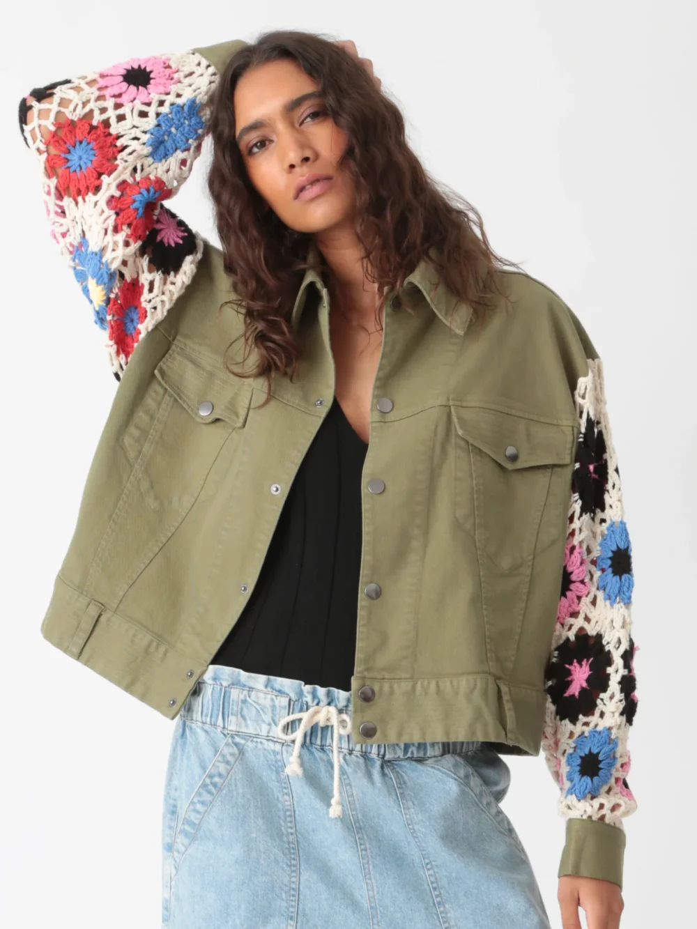 Dyed jacket with hand - crocheted sleeves in olive green, styled with black inner wear and light - colored drawstring jeans