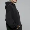 oversized-black-hoodie-model-half-side.jpg Model wearing oversized black hoodie (half-side view)