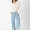 White openwork knitted sweater with light blue linen - cotton pants