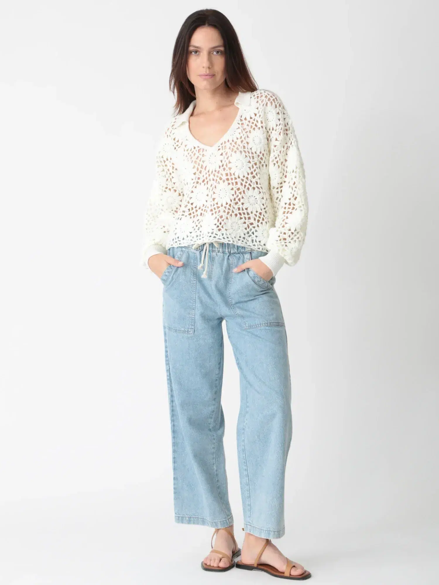 White openwork knitted sweater with light blue linen - cotton pants