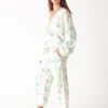 100% linen printed loungewear set with green plant and palm tree prints on white background, including a top and wide - leg pants, casual and comfortable design