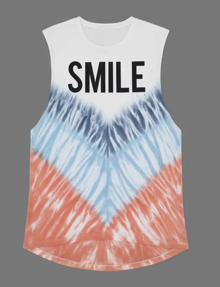 Woman wearing a “SMILE” graphic tie - dye sleeveless tank top with white pants against a gray background.