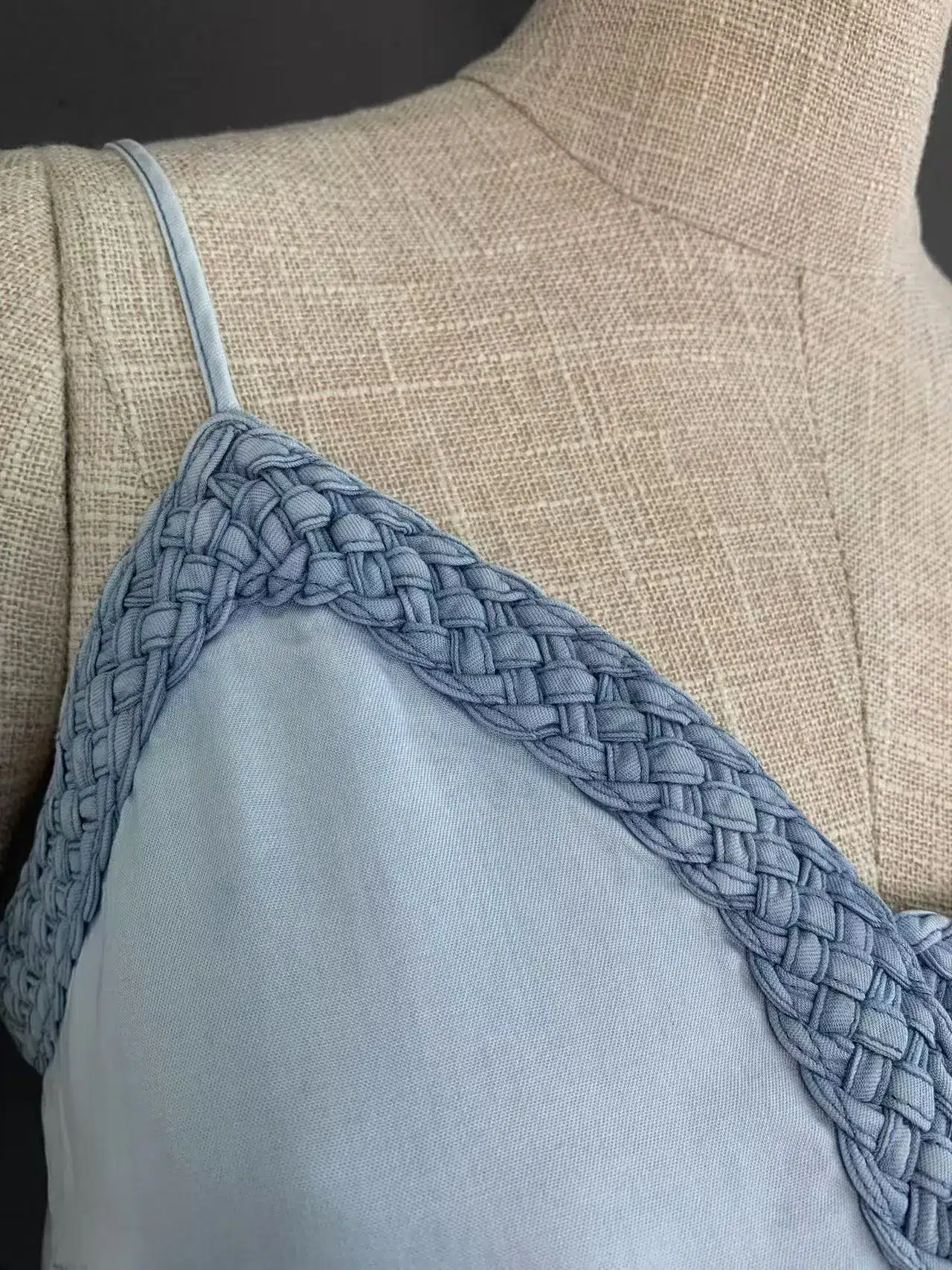 Back view of the crochet trim V-neckline with a subtle cutout on a light grey blue midi dress