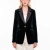 Emerald green velvet blazer with satin lapels on model