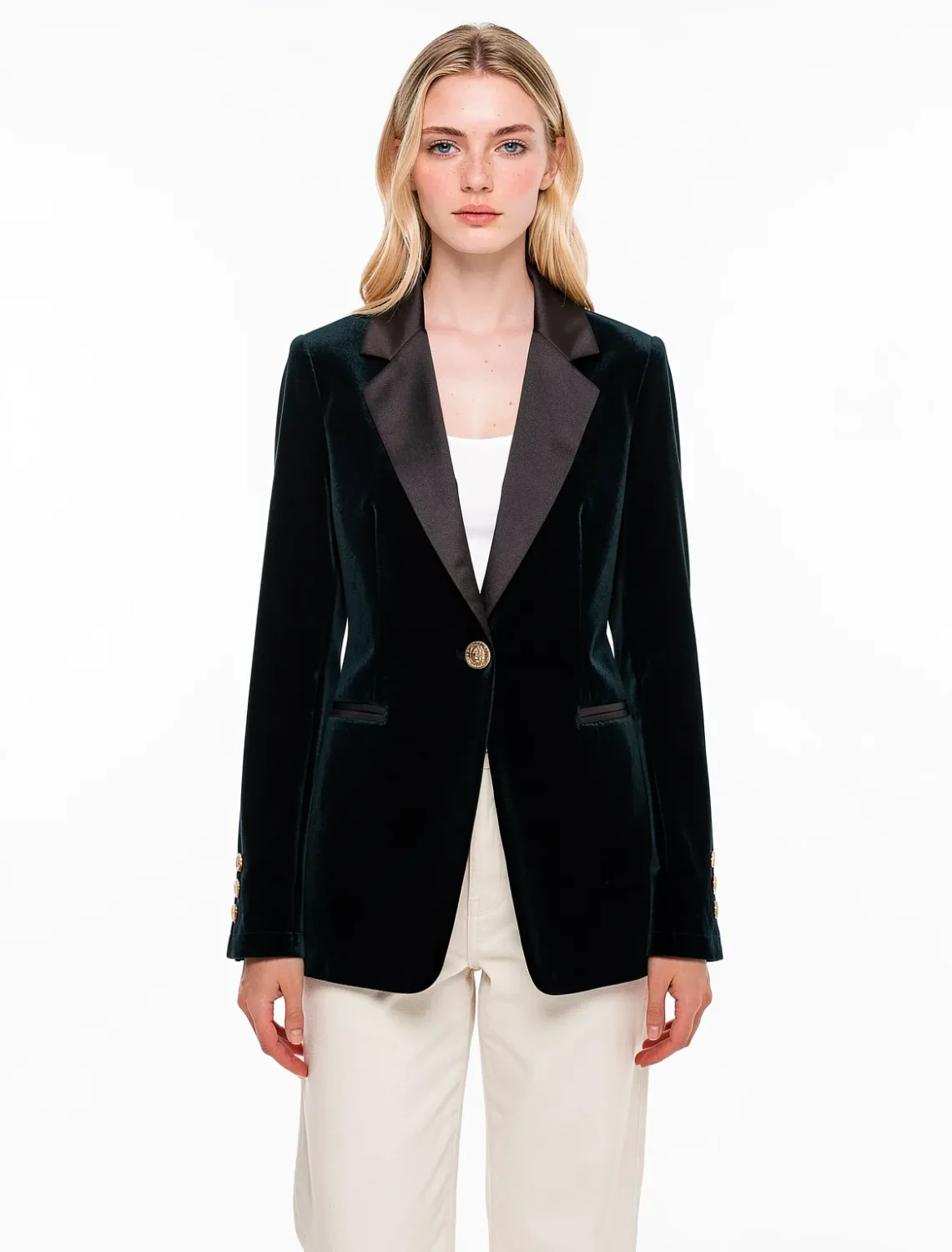 Emerald green velvet blazer with satin lapels on model