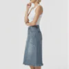 Frayed hem denim midi skirt made of denim fabric, paired with a white tank top, featuring a casual style, suitable for daily wear.