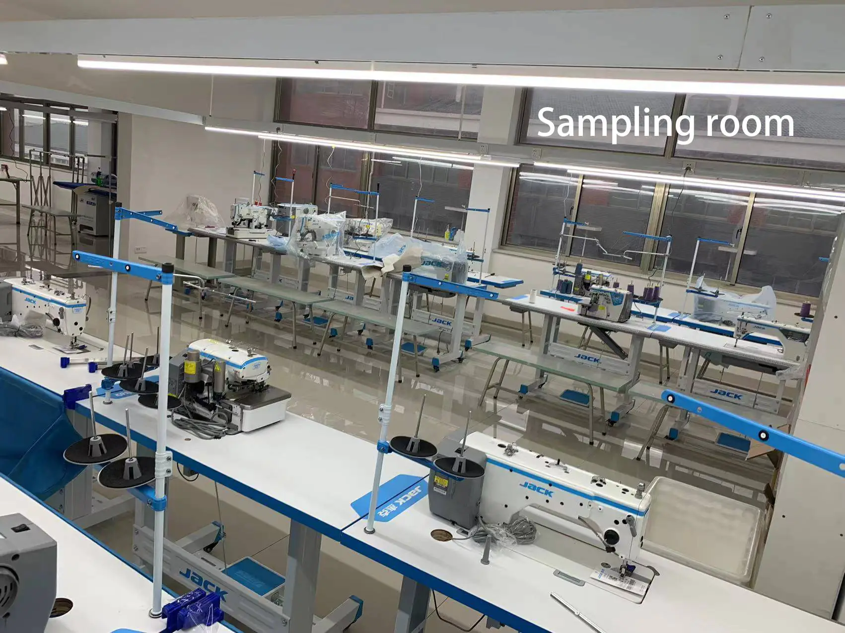 Garment sampling room with JACK brand sewing machines, suitable for small-batch sample making & process proofing.