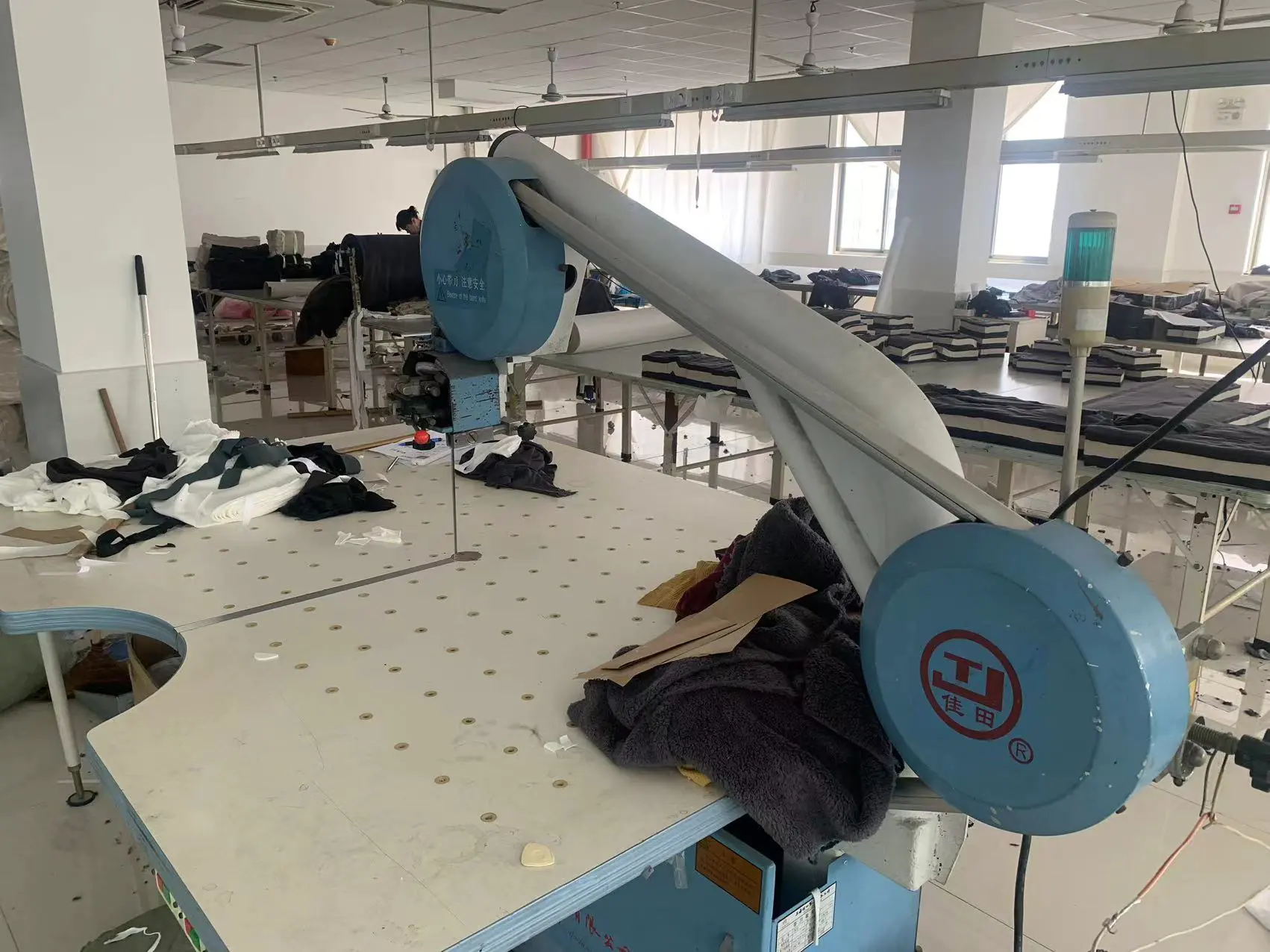 Jiataian brand cutting equipment in garment factory, practical & efficient for fabric cutting processing.