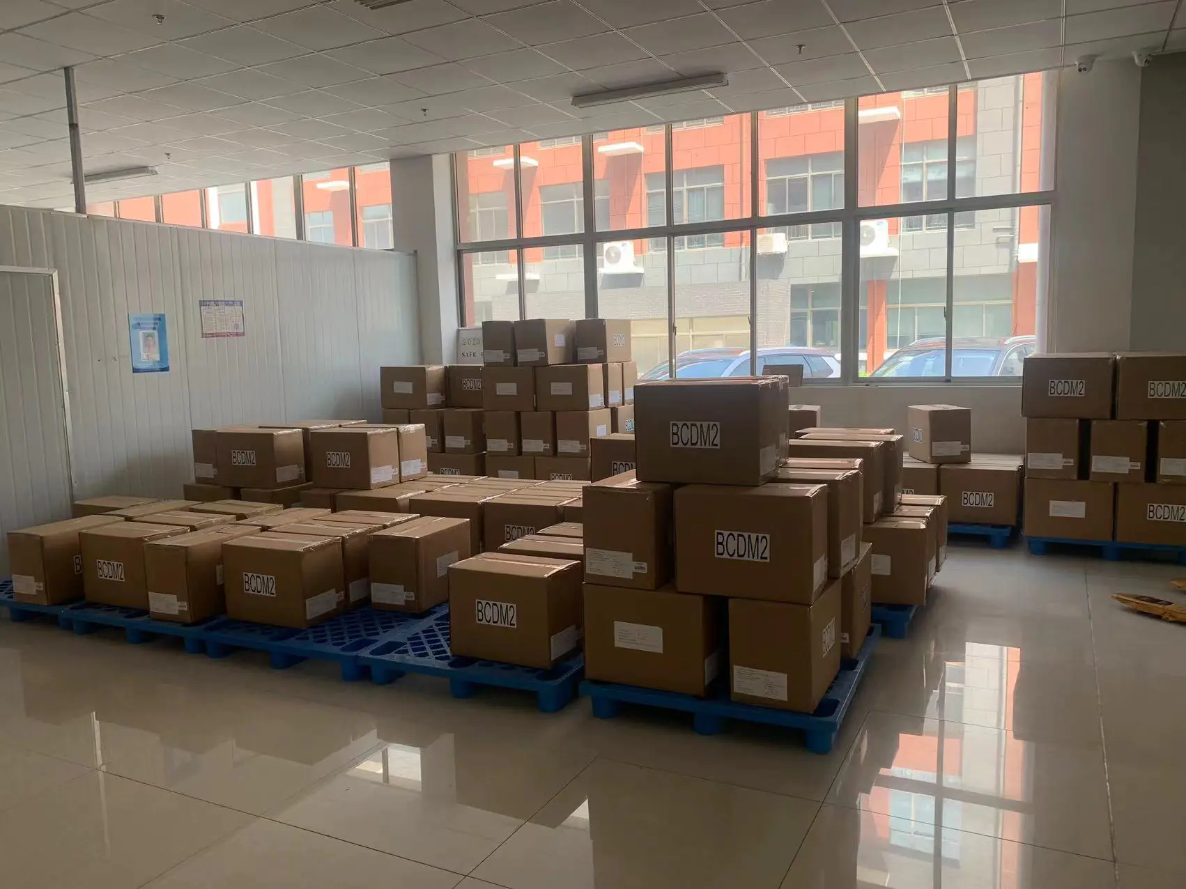 Finished goods storage area in garment factory with classified storage, professional shelves & environmental management, suitable for efficient finished goods storage.