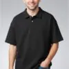 black-oversized-short-sleeve-polo-shirt-model-display.jpg Model wearing black oversized short sleeve polo shirt