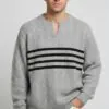 Model wearing light gray notch - neck cable - knit stripe sweater
