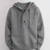 Display of gray hooded henley - style sweater