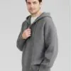 Model wearing gray hooded henley - style sweater