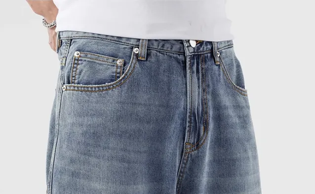 Model wearing light blue loose-fit jeans (half-side view)