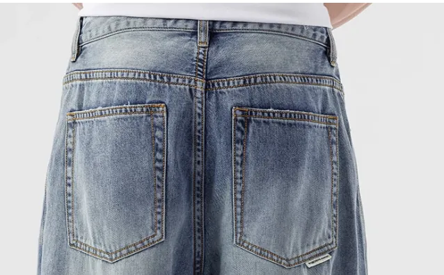 Model wearing light blue loose-fit jeans (back view)