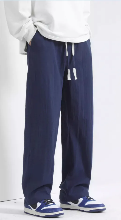 navy-blue-wide-leg-drawstring-trousers-model-side.jpg Model wearing navy blue wide-leg drawstring trousers (side view)