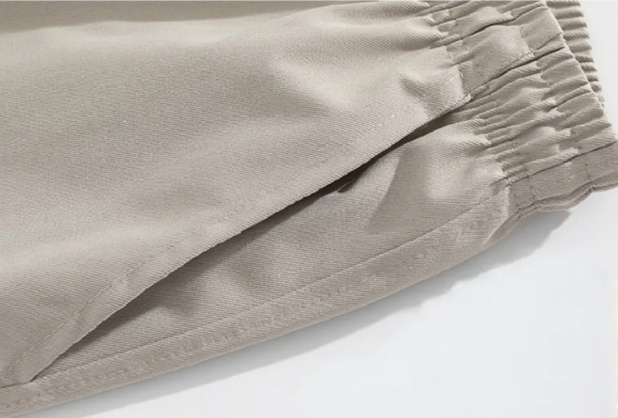 Detail view of light beige drawstring wide-leg trousers (fabric texture and waist detailing)