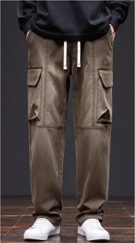 Model wearing brown drawstring cargo trousers with multiple pockets (front view)