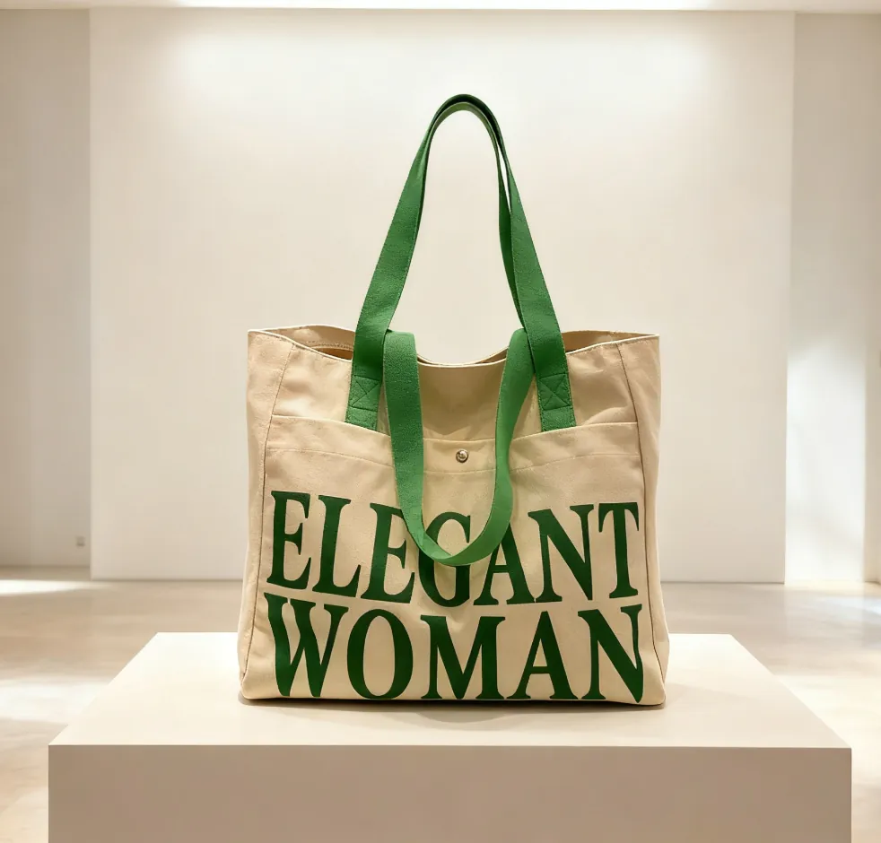 Beige canvas tote bag with "ELEGANT WOMAN" green print and green straps (still life)