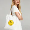 smiley-face-canvas-tote-bag-model.jpg Model carrying smiley face canvas tote bag