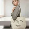 electric-rose-custom-logo-canvas-tote-bag-model.jpg Model carrying canvas tote bag with "Electric & Rose" custom logo