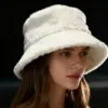 white-fuzzy-bucket-hat-model.jpg Model wearing white fuzzy bucket hat