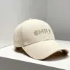 beige-smile-embroidered-baseball-cap.jpg Beige baseball cap with "SMILE" embroidery