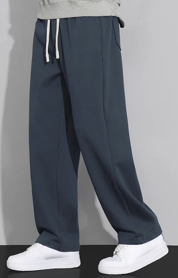 dark-blue-wide-leg-drawstring-trousers-model-side.jpg Model wearing dark blue wide-leg drawstring trousers (side view)